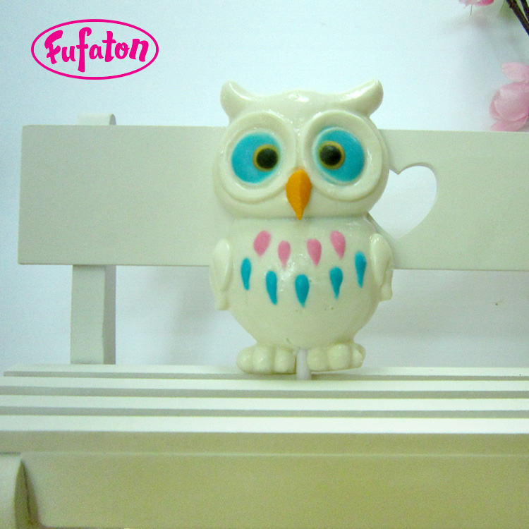 Owl shaped candy lollipop with hand decoration